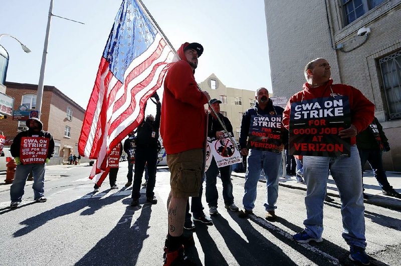 Verizon workers picket Wednesday morning outside one of the company’s facilities in Philadelphia. 