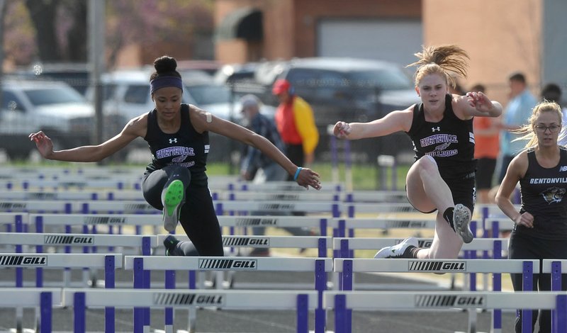 Fayetteville hurdlers Lauren Holmes (left) and McKenzie Penne compete Friday in the girls 100 meter hurdles during the Fayetteville Bulldog Relays track meet at Ramay Junior High.