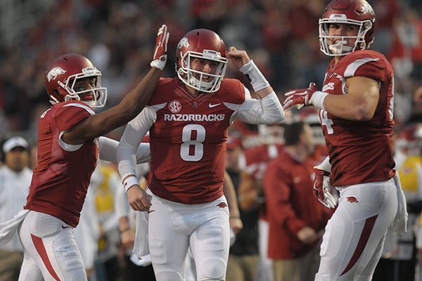 Austin Allen (8) of Arkansas celebrates a touchdown pass with Jared Cornelius (left) and Hunter Henry (right) against UT-Martin Saturday, Oct. 31, 2015, during the fourth quarter at Razorback Stadium in Fayetteville. 