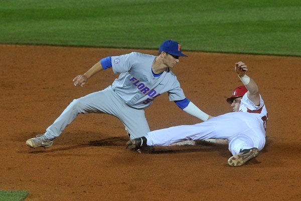 Arkansas baserunner Chad Spanberger is tagged out by Florida shortstop Dalton Guthrie as he tries to steal second base Thursday, April 14, 2016, at Baum Stadium.