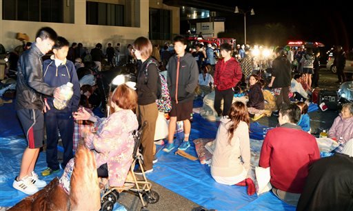 Stranded people gather outside a town hall of Mashiki, after an earthquake in Kumamoto, southern Japan, on Thursday, April 14, 2016.