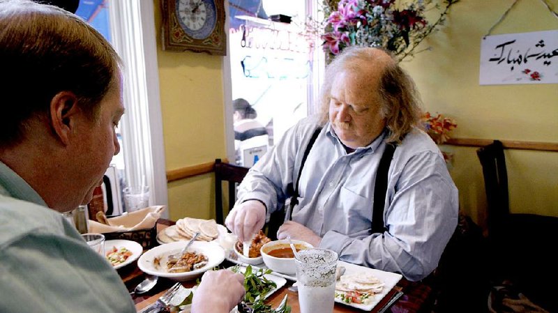 Jonathan Gold, (right) critic and raconteur, samples a dish in a modest ethnic restaurant in his hometown of Los Angeles in Laura Gabbert’s affectionate documentary City of Gold.
