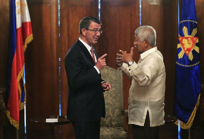U.S. Defense Secretary Ashton Carter talks with Philippines defense chief Voltaire Gazmin on Thursday in Manila.