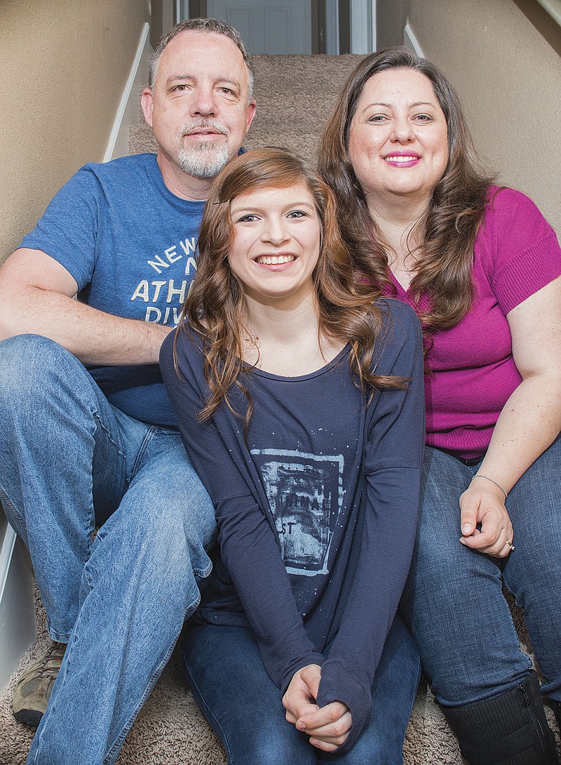 John and Tricia Goyer of Bryant are shown with 16-year-old Maria Goyer, who is one of seven children the 
couple adopted. 