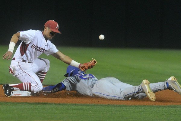 Arkansas second baseman Rick Nomura tries to make the play on Florida baserunner Buddy Reed as he steals second base in the first inning Thursday, April 14, 2016, at Baum Stadium.