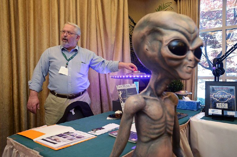 Tom Jensen of T-Toys & UFOs from Barnesville, Minn., talks about one of his flying saucer models at the Ozark Mountain UFO Conference in Eureka Springs.