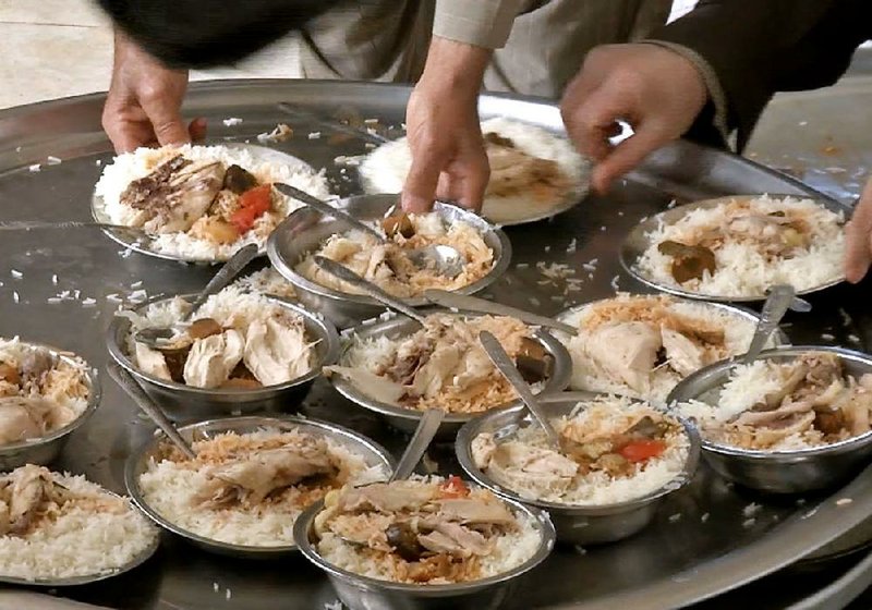 Volunteers at the Shrine of Sheikh Chouli cook chicken and rice for hundreds of needy people in Irbil, Iraq, each day. 