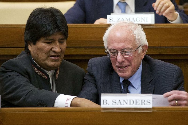 Bolivian President Evo Morales and Democratic presidential candidate Bernie Sanders sit together as guests of honor Friday at the Vatican. Sanders spoke, then flew home with his wife, Jane, shortly after. 