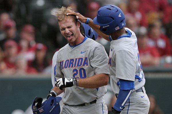 Florida center fielder Buddy Reed, right, congratulates first baseman Peter Alonso after he hit a home run in the sixth inning of a game against Arkansas on Saturday, April 16, 2016, at Baum Stadium in Fayetteville.