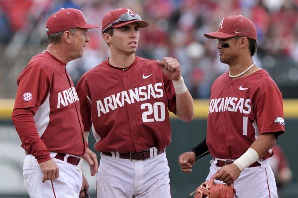 Arkansas coach Dave Van Horn (left) confers with third baseman Carson Shaddy (20) and second baseman Rick Nomura (1) during the game against Florida on Saturday, April 16, 2016, in Baum Stadium in Fayetteville. 