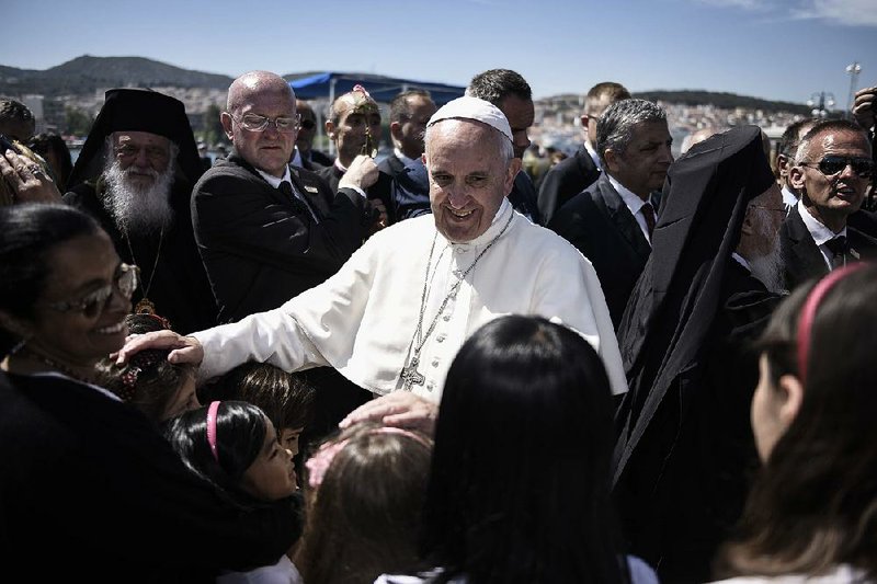 Pope Francis greets children Saturday at the Greek port of Mytilene on the island of Lesbos during a visit to the Moria refugee camp. 