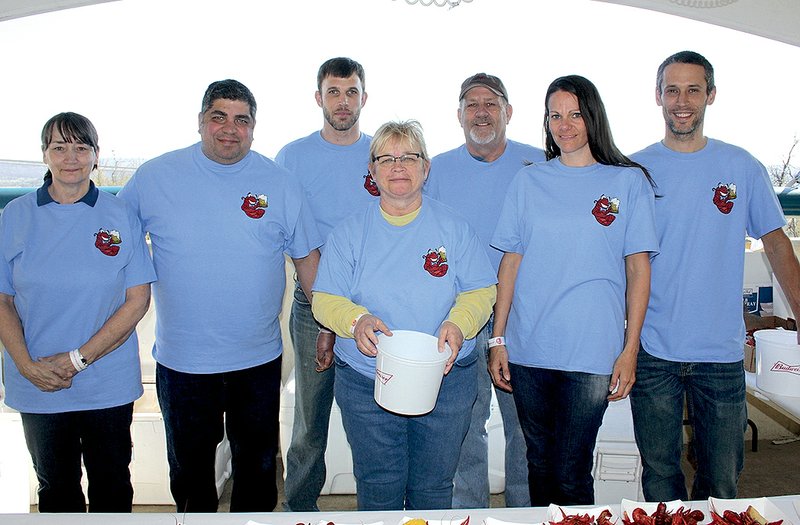Pam McPherson (from left), Chris Calleja, Chris Ingram, Darlene Harrell, Mike Gilbert, Tiffany Dixon and Brad Schrag serve crawfish at Ales and Tails on April 2.