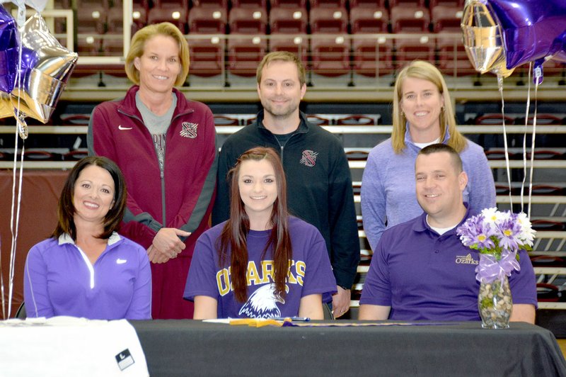 Graham Thomas/Siloam Sunday Siloam Springs senior Abby Cox signed a letter of intent to play basketball at the University of the Ozarks on Wednesday. Pictured with Cox are her mother Joey and dad Kevin, along with, back from left, Siloam Springs assistant coach Janet Moore, head coach Tim Rippy and assistant coach Kelley Waters.