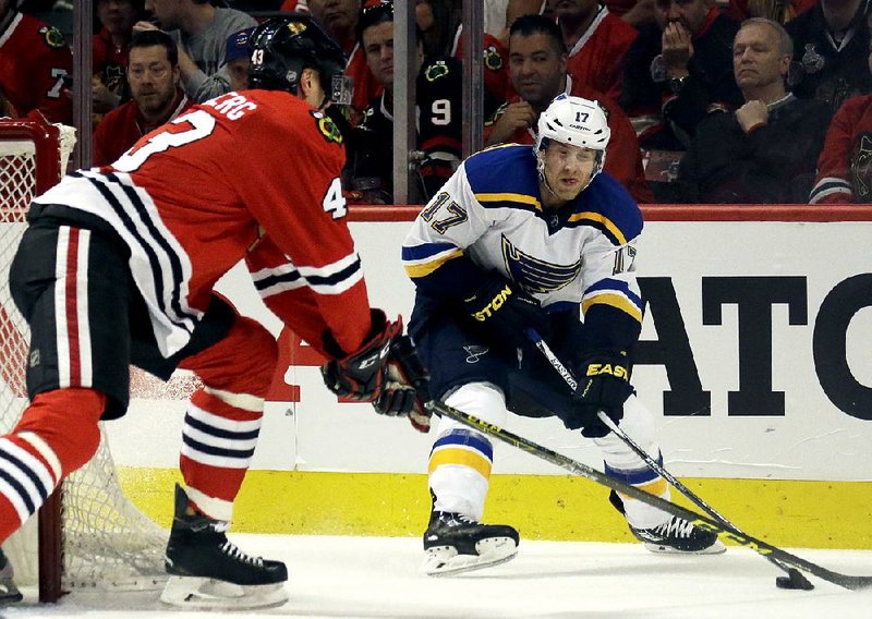 St. Louis Blues left wing Jaden Schwartz (right) passes against Chicago Blackhawks defenseman Viktor Svedberg during the first period of Sunday’s NHL playoff game in Chicago. The Blues won 3-2.
