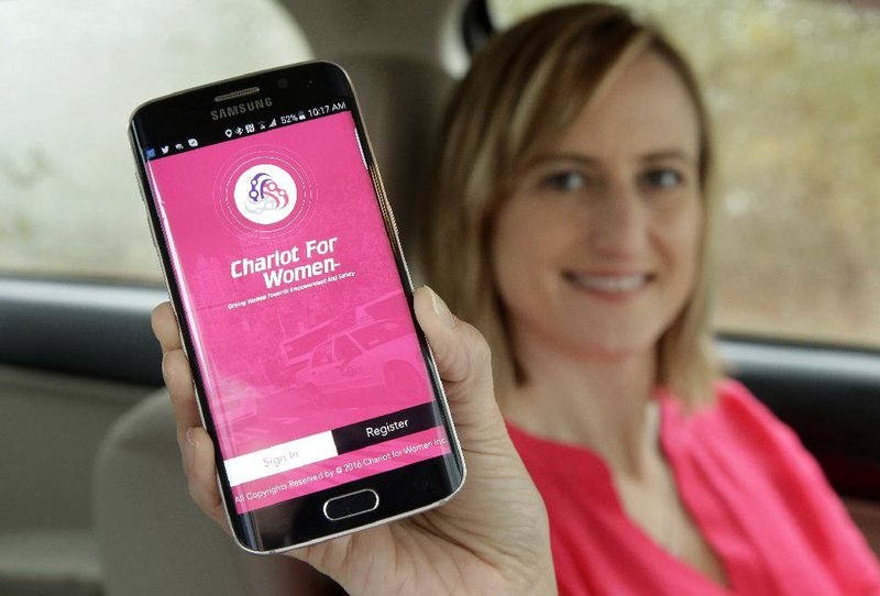 Kelly Pelletz, of Charlton, Mass., co-creator of the ride-hailing service Chariot for Women, displays the app on a mobile phone, in Charlton earlier this month.