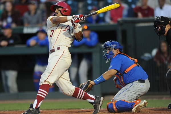 Arkansas shortstop Michael Bernal connects for a home run against Florida Friday, April 15, 2016, during the fourth inning at Baum Stadium in Fayetteville.