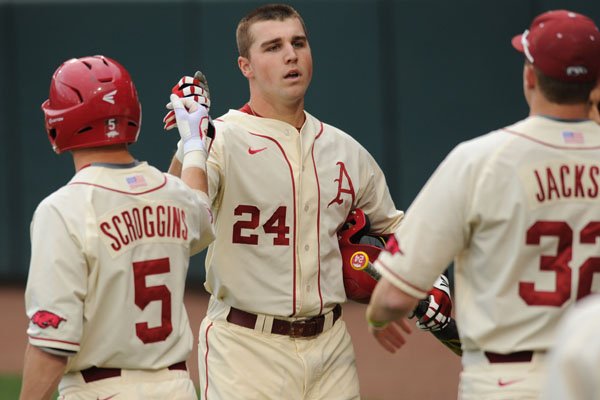 Arkansas right fielder Chad Spanberger is congratulated by Cody Scroggins (5) and Zach Jackson against Creighton Tuesday, April 19, 2016, after hitting a two-run home run during the second inning at Baum Stadium in Fayetteville.