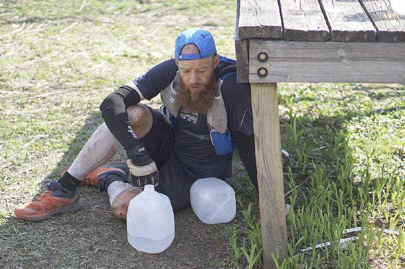 Gary Robbins rests during the 30th running of the Barkley Marathons at Frozen Head State Park in Warburg, Tenn., on April 4. Robbins completed 4½ loops before withdrawing because of hallucinations from lack of sleep. The race, which no one fi nished this year, is part orienteering, part ultra-marathon where runners attempt to complete five 20-mile loops within a 60-hour time limit where they search for hidden book caches deep in the woods throughout the park.