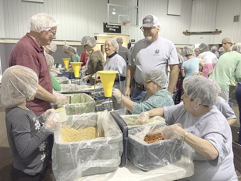 Photos Courtesy Prairie Grove Christian Church Members of Prairie Grove Christian Church put together meals that will be delivered to people in Haiti. The church partnered with The Pack Shack of Rogers for the food. The project was part of the church&#8217;s Great Serve, a day set aside to serve the community.