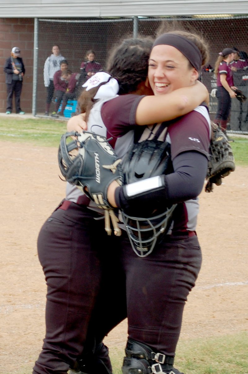 Graham Thomas/Herald-Leader Siloam Springs senior Heidi Fernandez hugs senior Morgan Curtis after the Lady Panthers recorded an out at the plate Saturday in the Lady Panther Invitational.