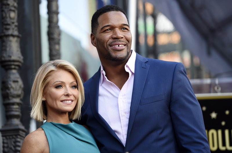FILE - In this Oct. 12, 2015 file photo, Kelly Ripa, left, poses with Michael Strahan, her co-host on the daily television talk show "LIVE! with Kelly and Michael," during a ceremony honoring Ripa with a star on the Hollywood Walk of Fame in Los Angeles. (Photo by Chris Pizzello/Invision/AP, File)
