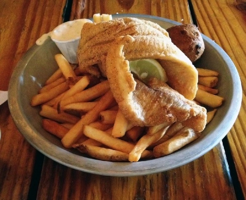 Fried catfish filets come with french fries and a hush puppy at Cock of the Walk. 