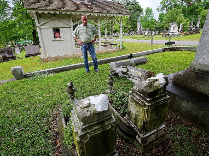 Scott Shepard, who has family buried at Mount Holly Cemetery, looks at vandalism at the cemetery Wednesday in Little Rock, where the statues of the well-known Basham girls (foreground) were broken off their grave markers. 