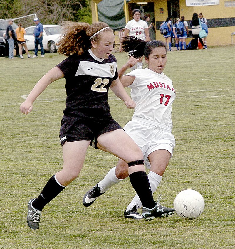 Photo by Rick Peck McDonald County&#8217;s Mabely Teodocio (17) battles a Neosho Lady Wildcat for possession during the Lady Mustangs&#8217; 3-0 loss Saturday in the Neosho Shootout.