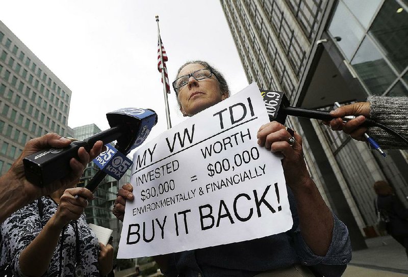 The owner of a 2015 Volkswagen stands outside federal court in San Francisco on Thursday, where Volkswagen agreed to fix or buy back nearly 500,000 diesel cars in the United States equipped with illegal emissions software.