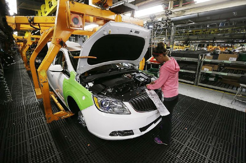 Final trim is installed on a Buick Verano at the Orion Assembly plant in Orion Township, Mich., in this file photo. The Detroit automaker’s shares briefl y topped $33 after it reported its first-quarter results Thursday.
