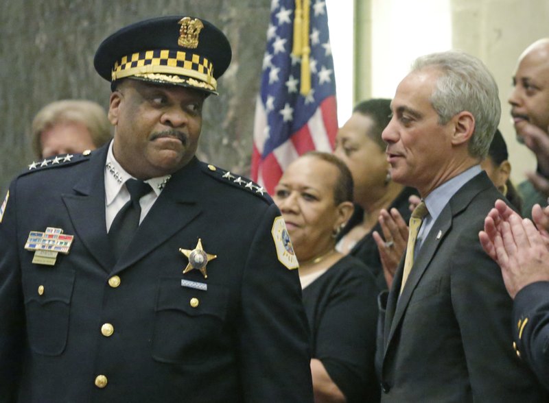 In this April 13, 2016 photo, Chicago Police Superintendent Eddie Johnson speaks with Mayor Rahm Emanuel at Johnson's swearing-in ceremony in Chicago. 
