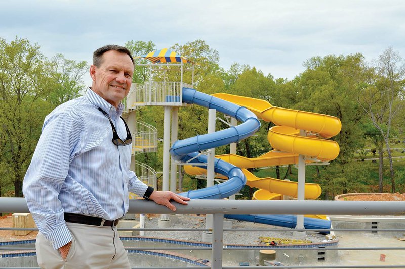 Batesville Mayor Rick Elumbaugh stands on the balcony of the new community center and aquatics facility that overlooks the outdoor water park that includes water slides, a dive pool and a lazy river.