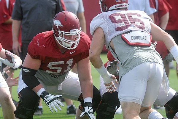 Arkansas offensive lineman Hjlate Froholdt (51) blocks defensive lineman Karl Roesler (96) during a practice Thursday, April 21, 2016, in Fayetteville. 