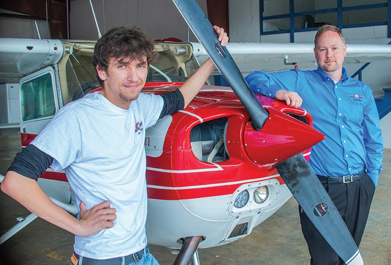 Ozarka College freshman Jacob Harness, left, and the college’s aviation-program director, Nick Lenczycki, stand in front of the Cessna 172 Skyhawk that Harness flew for his first solo flight earlier this month.