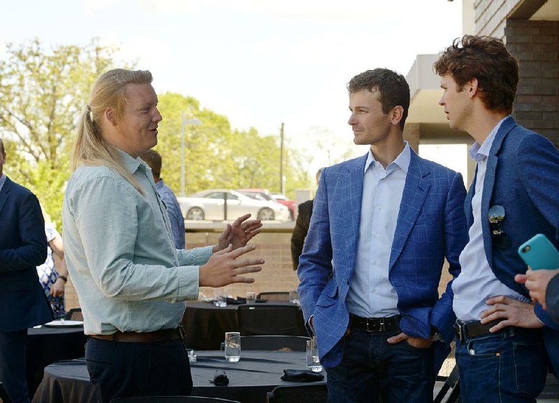 Jonathan McArthur (left), head gardener at the Samaritan Community Center, talks with brothers Steuart and Tom Walton. The center was awarded a $20,000 grant from the Walton Family Foundation to expand its garden. 