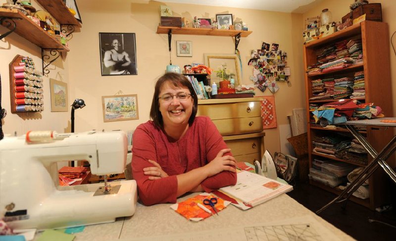 April Rusch, a trust officer with Arvest Assessment Management and a member of the Shiloh Museum of Ozark History's board of directors, enjoys sewing in her sewing room in her Fayetteville home.