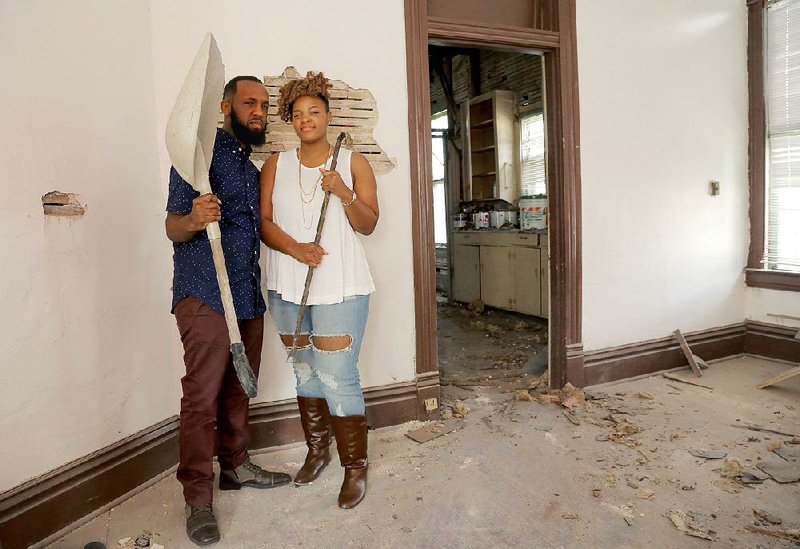 Chris James (left) and Sandrekkia Morning are two members of The Roots Art Connection who are helping renovate a house at 1020 W. 21st St. in Little Rock. James is the executive director of the nonprofit.