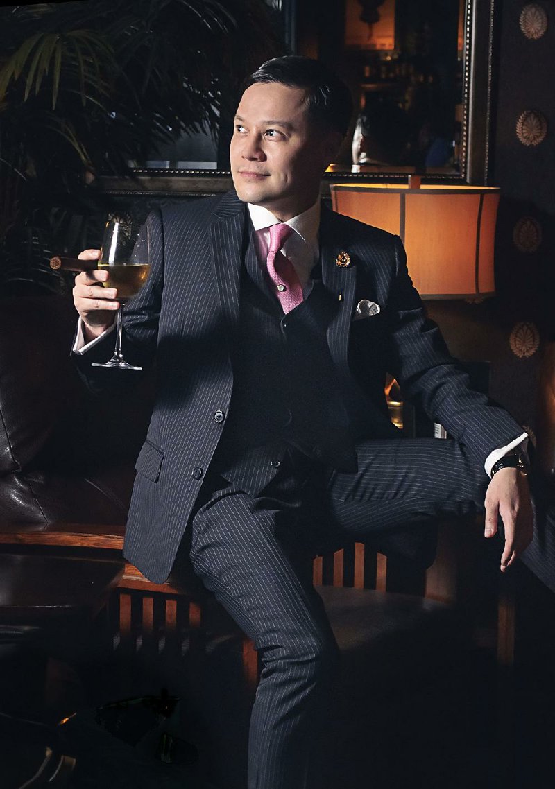 Joshua Price in his favorite suit: a navy wool creation he commissioned from Sam’s Tailor in Hong Kong. Featuring pale pink pinstripes, the suit, he says, “cost about a fourth of what it would have in the States, and I love a deal!” 