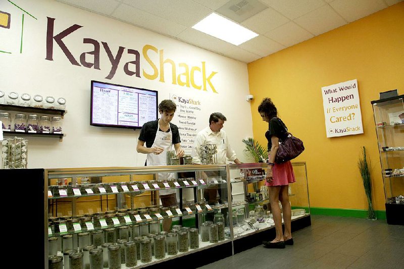 Employees at the medical marijuana dispensary Kaya Shack in Portland, Ore., help a customer make her choices. 