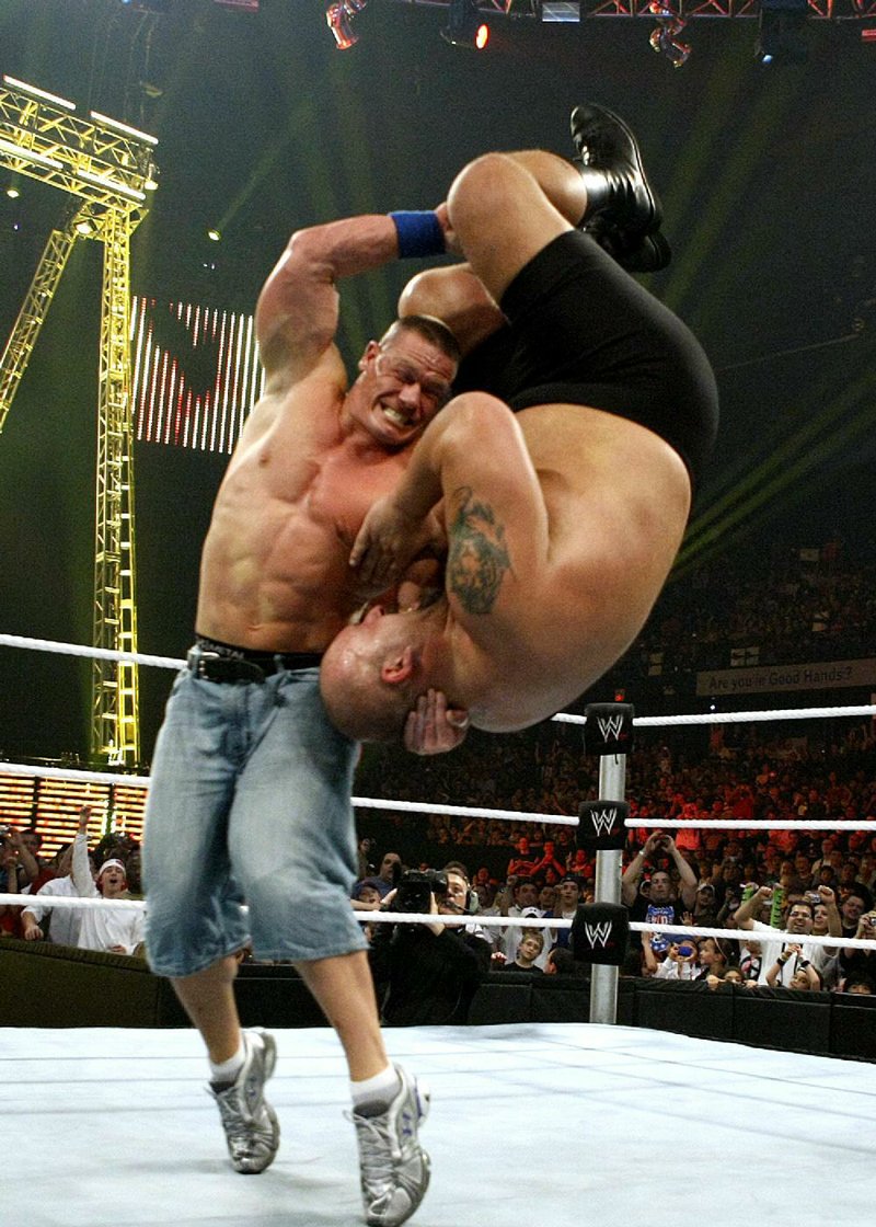 John Cena (left) slams The Big Show in a 2009 WWE Raw match. It doesn’t get any more real than this. Fayetteville-born Otus the Head Cat’s award-winning column of humorous fabrication appears every Saturday.