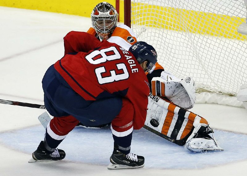 Philadelphia goalie Michal Neuvirth uses a shin pad to make a save during the third period Friday on a shot by Washington center Jay Beagle (83) during the Flyers’ 2-0 victory over the Capitals in Washington. Philadelphia will host Game 6 on Sunday with a chance to tie the series.