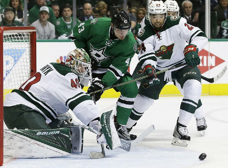 Minnesota goalie Devan Dubnyk (left) and defenseman Matt Dumba defend the goal against Dallas right wing Valeri Nichushkin (43) during the Wild’s 5-4 overtime victory over the Stars on Friday in Dallas.