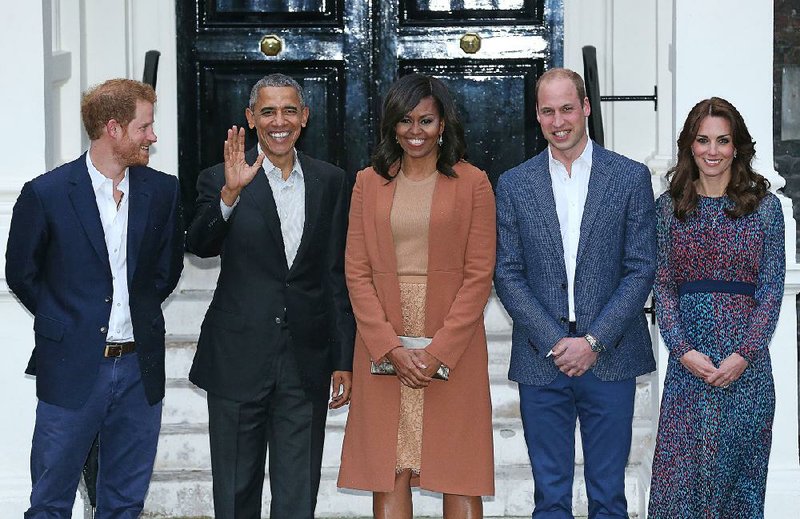 Britain’s Prince Harry (left) stands Friday with the Duke and Duchess of Cambridge (right) outside of Kensington Palace in London with United States President Barack Obama and his wife, Michelle, before a private dinner.