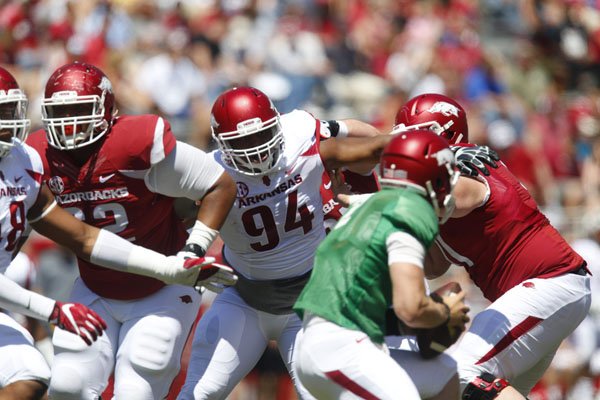 Arkansas defensive lineman Taiwan Johnson rushes quarterback Rafe Peavey during the Razorbacks' annual Red-White spring game Saturday, April 23, 2016, at Razorback Stadium in Fayetteville.