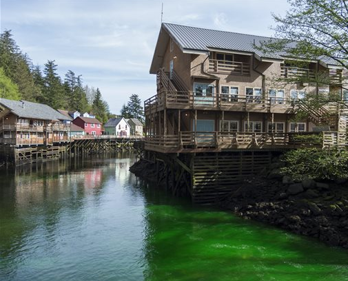 In this Wednesday, April 20, 2016, photo, green non-toxic dye makes its way through Ketchikan Creek in Ketchikan, Alaska. Ketchikan police talked to the man responsible for the dye, but he was not arrested or cited. 