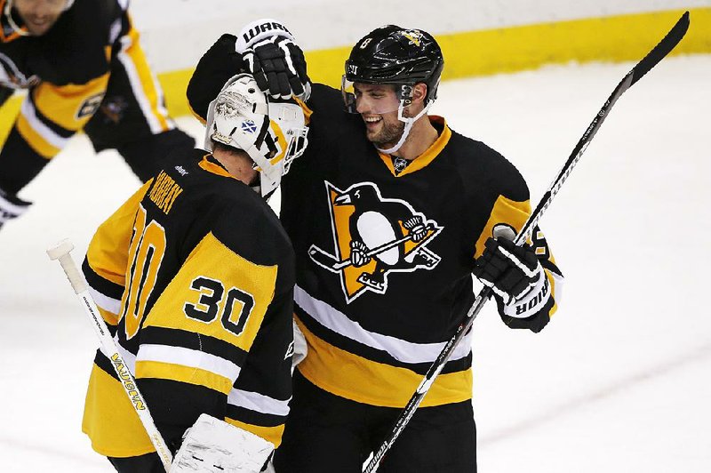 Pittsburgh goalie Matt Murray (left) and defenseman Brian Dumoulin celebrate after the Penguins eliminated the New York Rangers 6-3 on Saturday to win their NHL first-round playoff series.