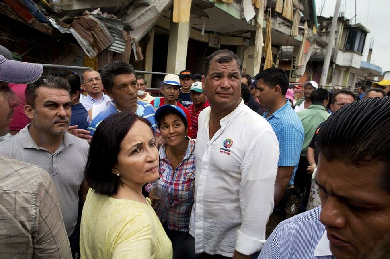 Ecuador's President Rafael Correa talks with residents as he visits an earthquake-damaged area, in Pedernales, Ecuador, Friday, April 22, 2016. 