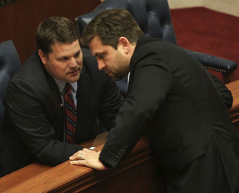 Sen. Bart Hester (left) and Senate President Pro Tempore Jonathan Dismang talk April 14 during wrangling over Medicaid funding. Hester, who initially opposed that measure, now is looking at cuts in the Arkansas Educational Television Network and higher-education budgets and an increase for foster care programs.