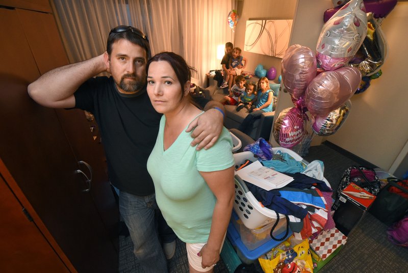 Andrew Krowne poses with his wife Jennifer and kids in their hotel room, Thursday, April 21, 2016, in Thousand Oaks, Calif.  