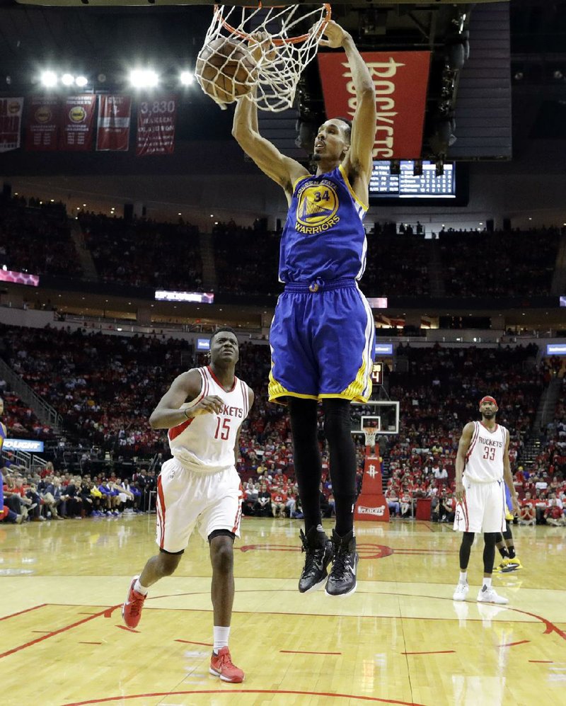 Golden State point guard Shaun Livingston dunks in front of Houston’s Clint Capela during the second half of Sunday’s NBA Western Conference playoff game. The Warriors outscored the Rockets 65-38 in the second half to cruise to a 121-94 victory and take a 3-1 series lead.